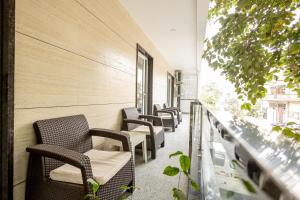a row of chairs lined up against a wall at Hotel Krish - Near Medanta and Fortis Hospital Gurugram in Gurgaon