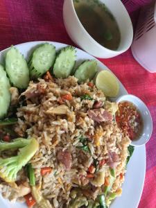 a plate of rice and vegetables and a bowl of soup at Paradise Hill in Chiang Dao