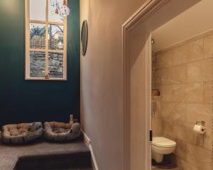 a bathroom with a toilet and a window at West View in Milnthorpe