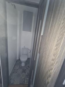 a small bathroom with a toilet in a hallway at Modern Studio flat(dedicated) in Vilnius