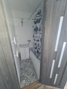 a small bathroom with a toilet and a sink at Modern Studio flat(dedicated) in Vilnius