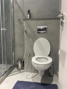 a small bathroom with a toilet and a shower at Trendy Apartment in Durban