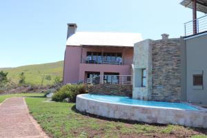 a house with a swimming pool in front of it at Segulah Guesthouse in Mossel Bay