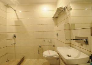 a bathroom with a toilet and a sink at HOTEL PEGAAM in Amritsar
