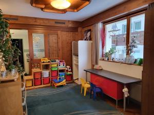 a kitchen with a counter and chairs in a room at Pension Heino in Saas-Grund