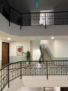 a staircase in a house with white walls at Olive Palace Road - by Embassy Group in Bangalore