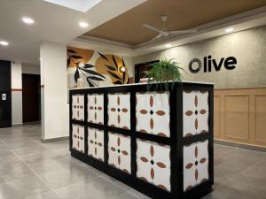 an office lobby with a wall with flowers on it at Olive Palace Road - by Embassy Group in Bangalore