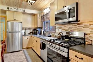 a kitchen with a stainless steel stove top oven at 2387- Hidden Loft Chalet cabin in Big Bear City