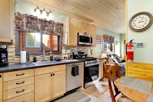 a kitchen with a sink and a stove top oven at 2387- Hidden Loft Chalet cabin in Big Bear City