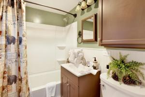 a bathroom with a sink and a toilet and a shower at 2387- Hidden Loft Chalet cabin in Big Bear City