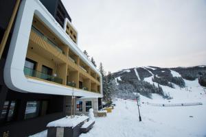 a building on a ski slope in the snow at City escape apartment Bjelasnica in Bjelašnica