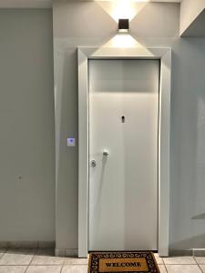 a white elevator with a door in a room at City Centre Apartment in Patra