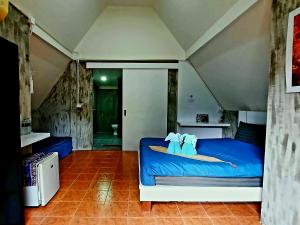 a bedroom with a blue bed with two elephants on it at Cashewnut Tree Resort in Ko Lanta