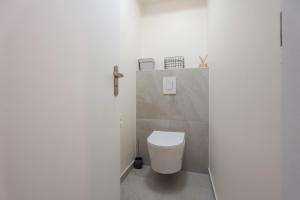 a bathroom with a white toilet in a room at LE N'ESPRESSO in Mulhouse