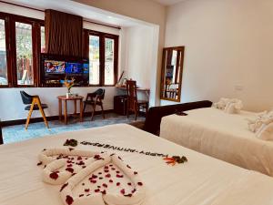 a hotel room with two beds with flowers on them at Vida Loca Sunset Beach Resort in Phu Quoc
