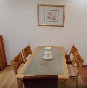 a dining room table with chairs and a picture on the wall at Ferienwohnung Hansi 