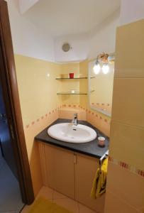 a bathroom with a sink and a mirror at Casa San Brasi di Mariano e Lucia in Acireale