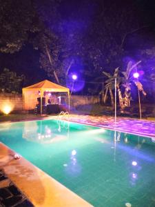 a swimming pool at night with a gazebo at Silva Rest in Unawatuna