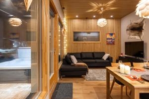 a living room with a couch and a tub at Villa Blueberry in Rovaniemi