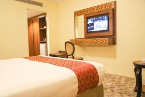 Postel nebo postele na pokoji v ubytování Abraj Al Tayseer Tuwa Hotel