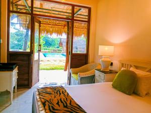 a bedroom with a bed and a sliding glass door at Sigiriya Elegant Resort in Sigiriya