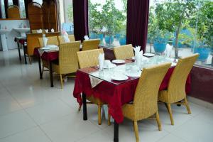 a dining room with a table and chairs at Garden Residents Uttara - Lake View in Dhaka