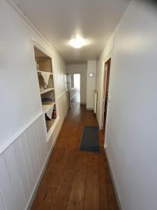 a hallway of a room with a hard wood floor at Maison d'hôtes du Faubourg Charrault Saint Maixent L'Ecole in Saint-Martin-de-Saint-Maixent