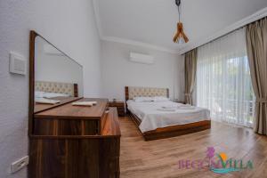 a bedroom with a bed and a large mirror at BegonVilla Fethiye-Göcek in Muğla +20 photos