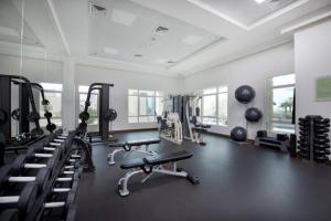 a gym with several treadmills and machines in it at Spacious 2BR apartment in Marina Crown in Dubai