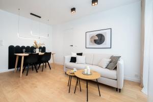 un soggiorno con divano bianco e tavolo di Apartament New York Premium- ścisłe centrum - by Kairos Apartments a Katowice