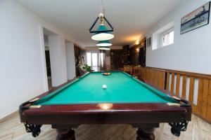 a pool table in the middle of a room at Hotel Zemo Aragvi in Gudauri