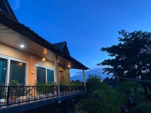 a house with a balcony at night at Lemonwood cottage in North Lakhimpur