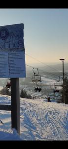 a ski lift with people on it in the snow at Nina`s GuestHouse, 30m2, 75m2 ja 85m2 tai koko talo 190m2 in Jämsä