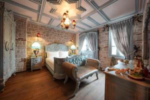a bedroom with a bed and a chair in it at Naz Su Cunda in Cunda +161 photos