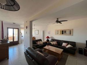 a living room with couches and a ceiling fan at 6CHK4 Villa 6 personnes dans résidence in Collioure