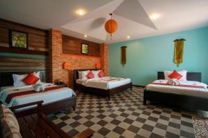 a bedroom with two beds and a checkered floor at RESIDENCE 1960 in Siem Reap