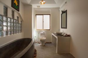 a bathroom with a bath tub and a sink at RESIDENCE 1960 in Siem Reap +65 photos