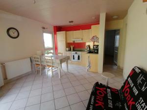 a kitchen and dining room with a table and chairs at Appartement au calme près du lac d'Annecy in Saint-Jorioz