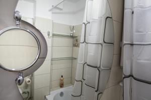 a bathroom with a mirror and a sink at Casa Rusu -Victoria-Self check in-24h in Reşiţa +30 photos