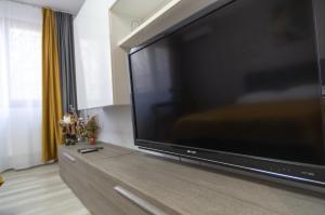 a large flat screen tv sitting on top of a entertainment center at Casa Rusu -Victoria-Self check in-24h in Reşiţa