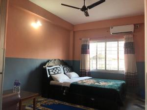A bed or beds in a room at Krishna Inn
