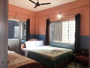 A bed or beds in a room at Krishna Inn