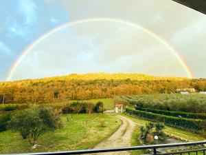 a rainbow in the sky over a dirt road at Anna&Franco Guest House in Isernia