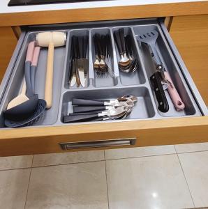 a drawer filled with cooking utensils in a kitchen at Casa Rusu -Victoria-Self check in-24h in Reşiţa