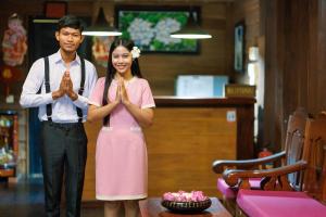 a man and a woman praying in front of a table at RESIDENCE 1960 in Siem Reap