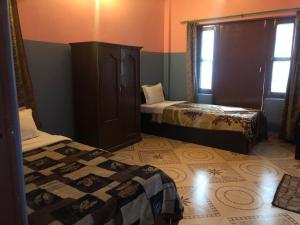 A bed or beds in a room at Krishna Inn