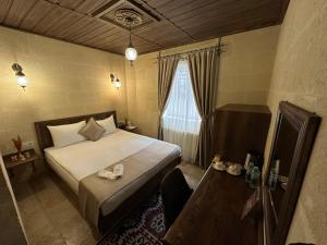 Postel nebo postele na pokoji v ubytování Virtus Cappadocia Hotel Göreme