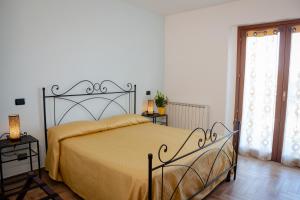 a bedroom with a large bed with a yellow blanket at Villa Marianna in Vasto