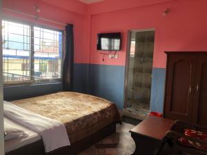 A bed or beds in a room at Krishna Inn