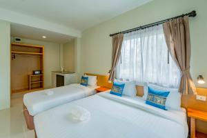 Letto o letti in una camera di Lightplus Khao Lak